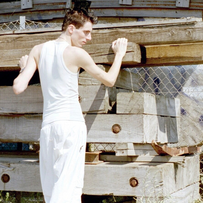 Me, that is leaning against stacked wood in a sunny spot.